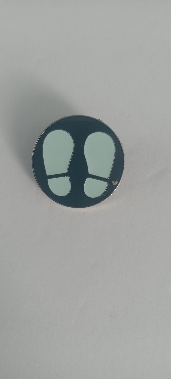 Disney black footprints pin.